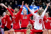 Lakeville North players celebrate after beating East Ridge during the Class 4A volleyball semifinals