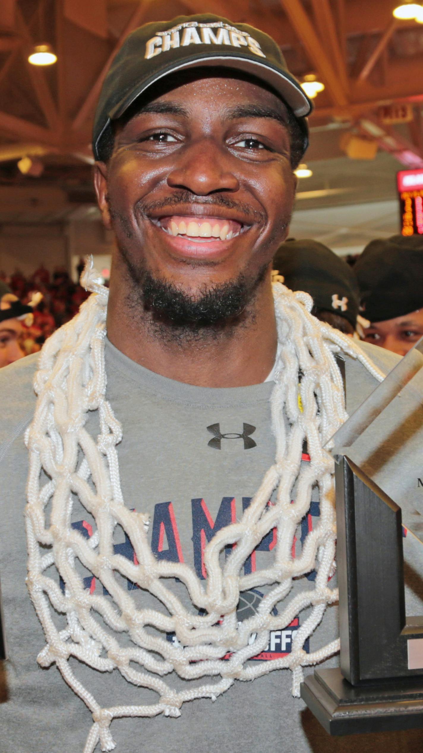 Stony Brook's Jameel Warney celebrates while wearing the net and displaying his MVP trophy celebrate following their 80-74 win over Vermont in an NCAA college basketball game in the championship of the American East Conference men's tournament, Saturday, March 12, 2016, in Stony Brook, N.Y. (Daniel De Mato/Newsday via AP) NYC OUT, NO SALES