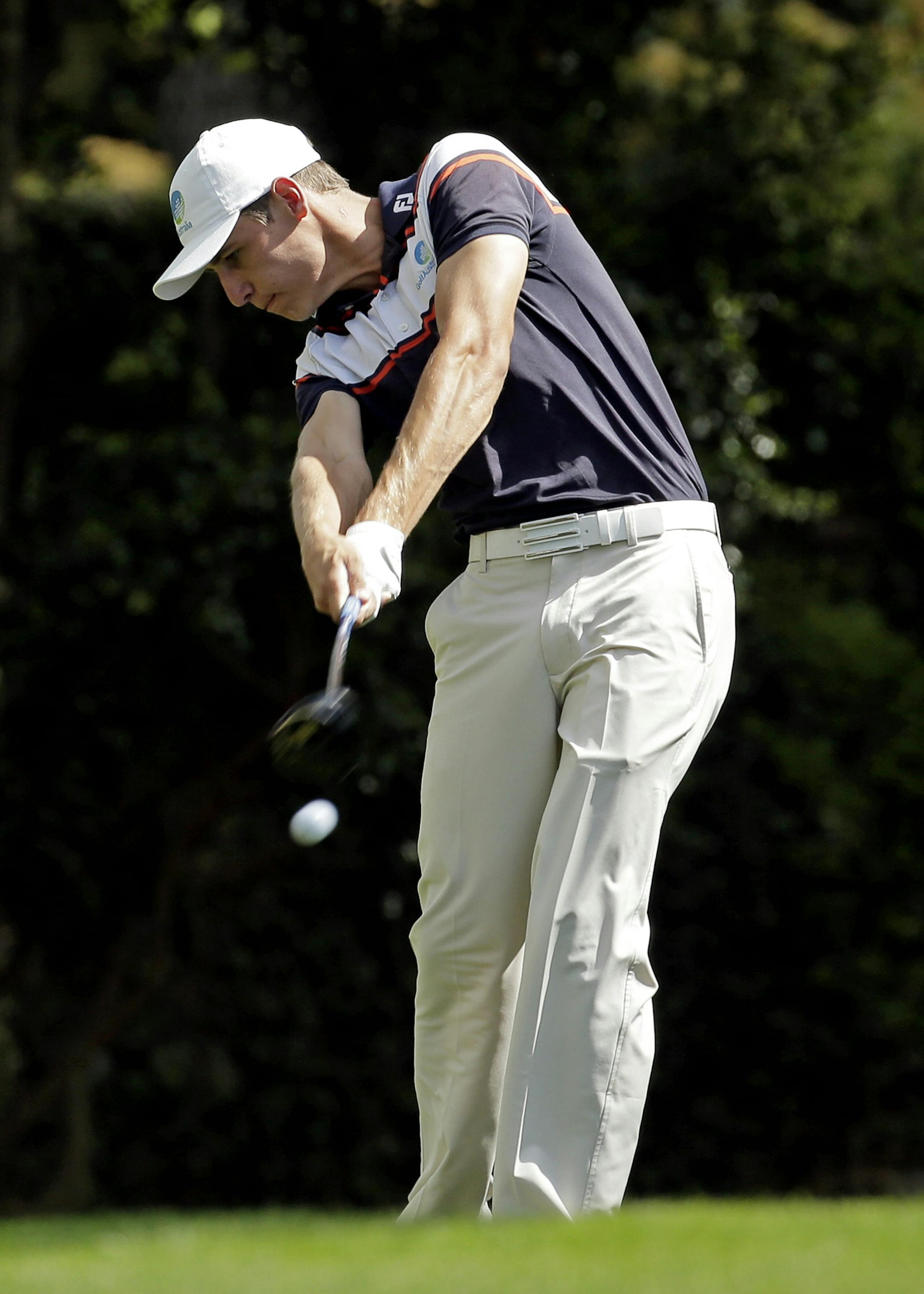 Oliver Goss, of Australia, tees off on the second hole during the fourth round of the Masters golf tournament Sunday, April 13, 2014, in Augusta, Ga. (AP Photo/Charlie Riedel)