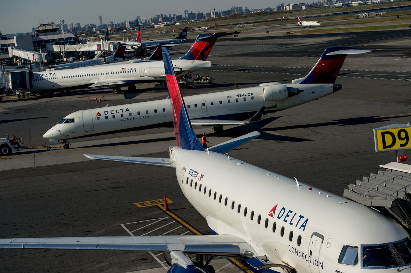 Delta Air Lines Inc. planes sit on the tarmac at LaGuardia Airport (LGA) in New York, U.S., on Monday, Oct. 21, 2013. Delta Air Lines Inc. is scheduled to release earnings figures on Oct. 22. Photographer: Ron Antonelli/Bloomberg