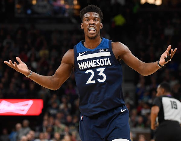 Minnesota Timberwolves guard Jimmy Butler (23) looked to an official for a foul call after he scored a basket in the first half against the Denver Nug