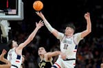 UConn's Donovan Clingan reaches for the ball as Purdue's Zach Edey defends in the NCAA title game won by Connecticut on April 8. Both Clingan and Edey