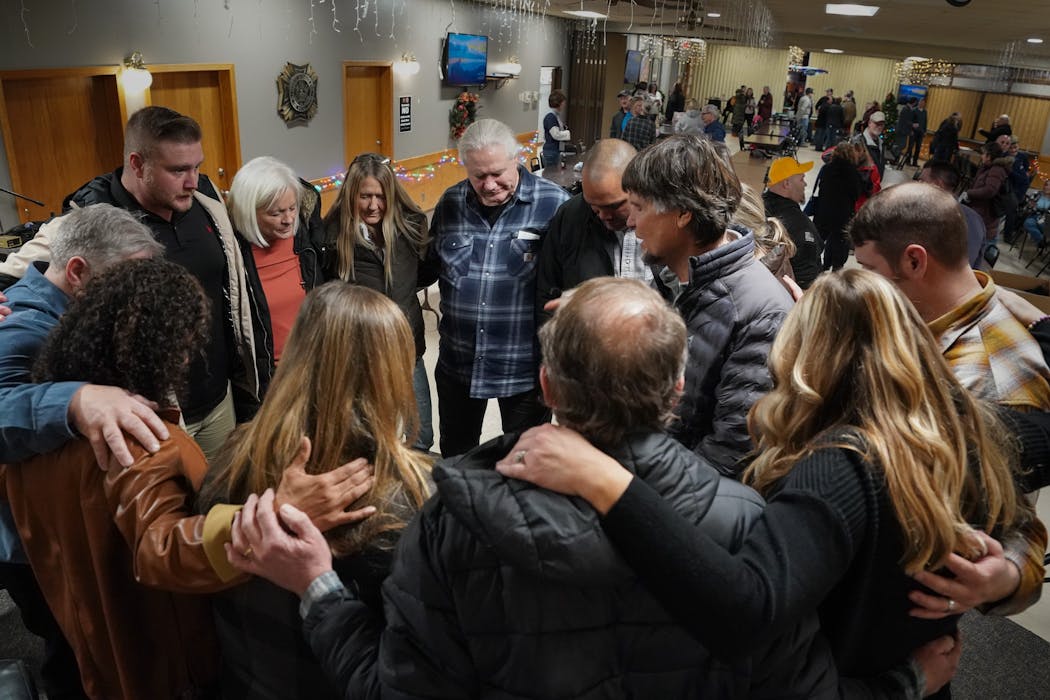 A group huddled in prayer during a town hall event in Fergus Falls on Jan. 6, 2024. Steve Boyd, who is running against Michelle Fischbach in Minnesota’s Seventh Congressional District, hosted the event on the anniversary of the Jan. 6 attacks at the U.S. Capitol. Those in attendance watched a film that blames much of the violence that day on escalation by law enforcement.