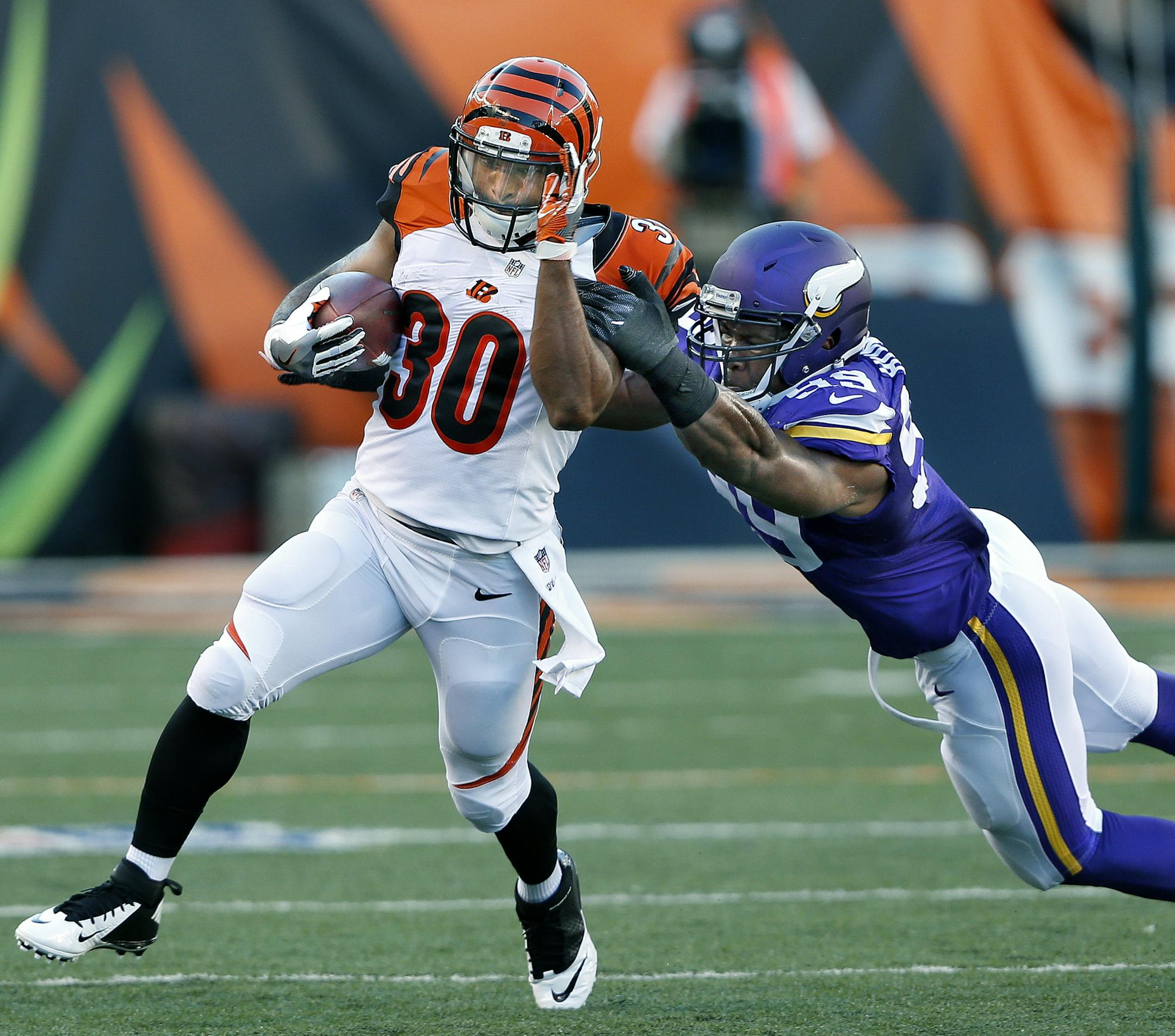 Cincinnati Bengals running back Cedric Peerman (30) is tackled by Minnesota Vikings defensive end Danielle Hunter (99) during the first half of an NFL preseason football game, Friday, Aug. 12, 2016, in Cincinnati. (AP Photo/Frank Victores) ORG XMIT: MIN2016081415241229