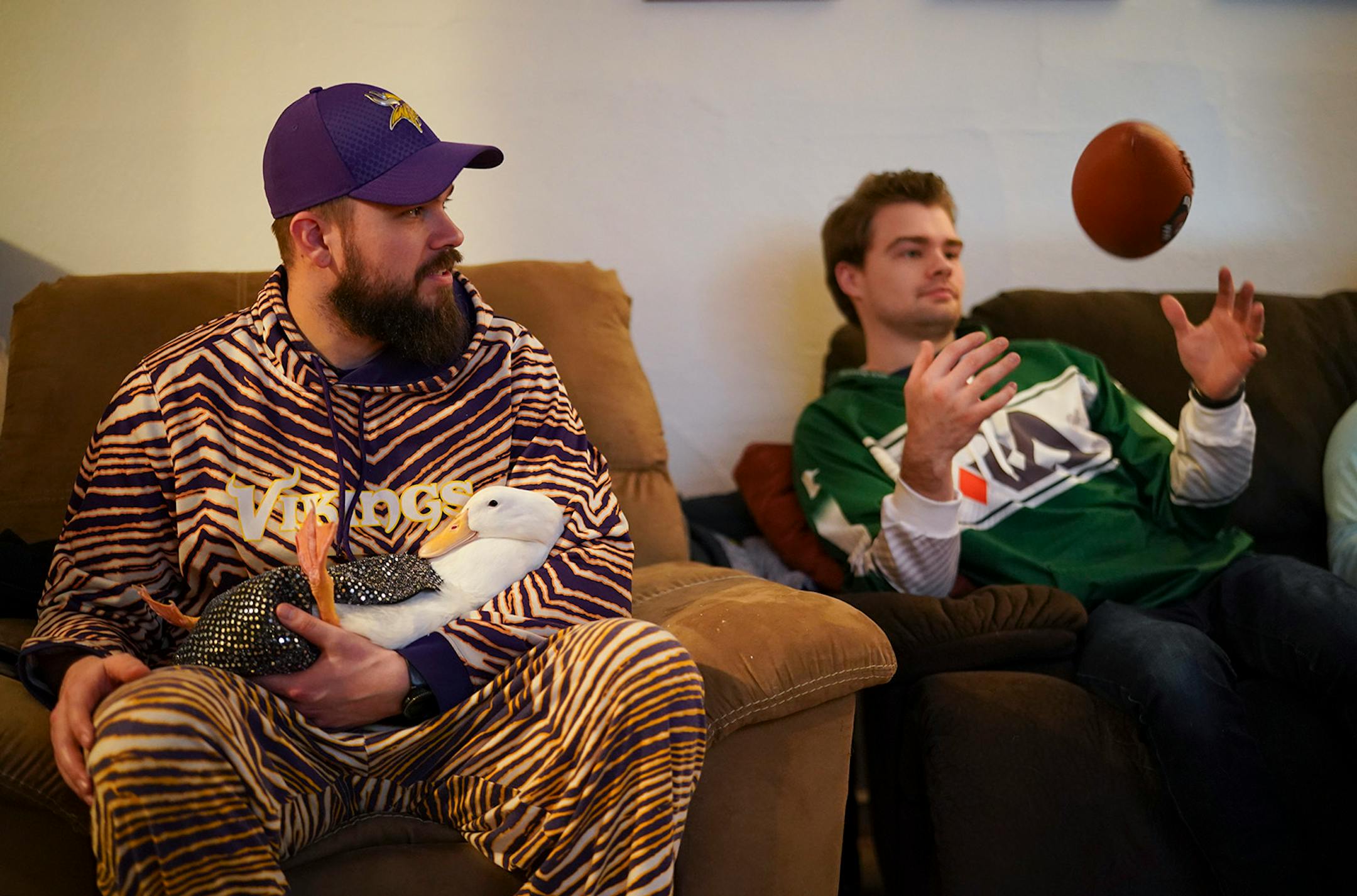Ben Afquack snuggled in the lap of his owner Derek Johnson while watching the Super Bowl with friends, including Corey Bahr Sunday night.