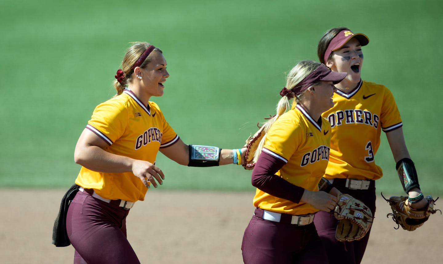 Gopher pitcher Amber Fiser left, Carlie Brandt and Makenna Partain