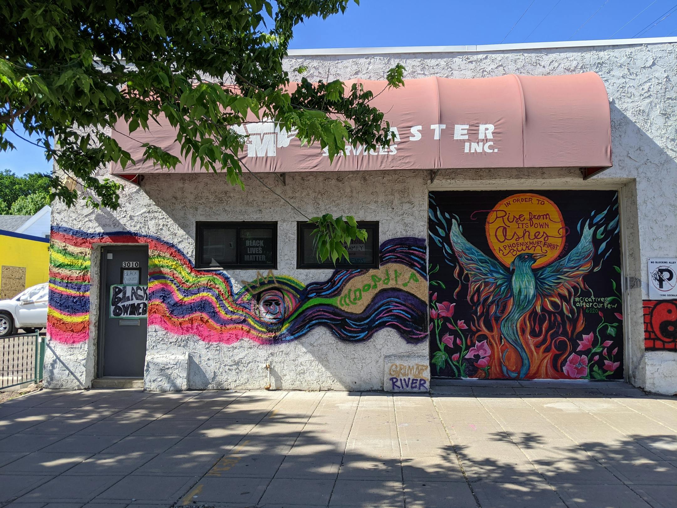 The artist collective loosely known as #creativesaftercurfew calls for a new future on their mural painted on Black-owned business Disaster Services Inc. at 3010 E Lake St.