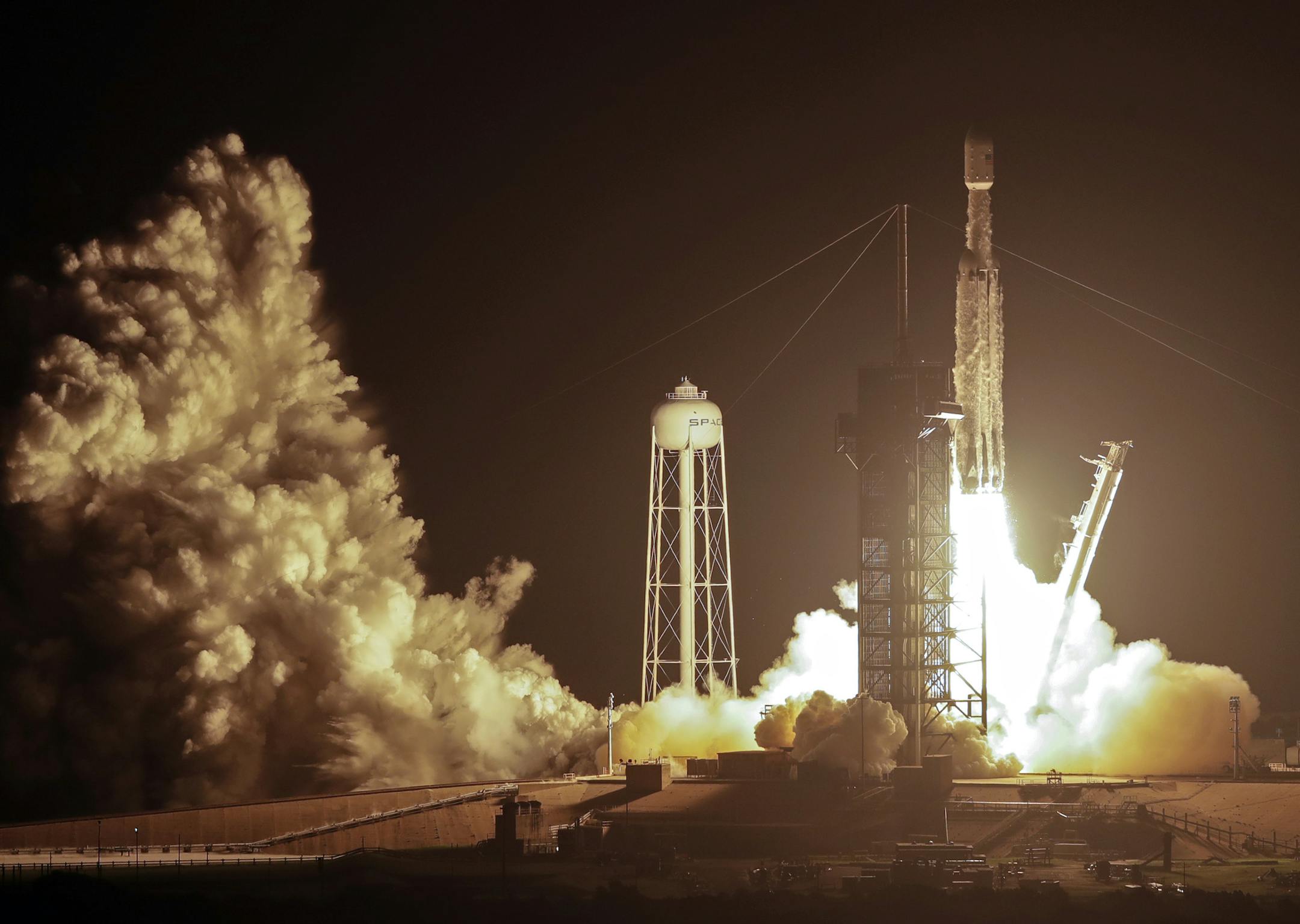 A SpaceX Falcon heavy rocket lifts off from pad 39A at the Kennedy Space Center in Cape Canaveral, Fla., early Tuesday, June 25, 2019. The Falcon rocket has a payload military and scientific research satellites. (AP Photo/John Raoux) ORG XMIT: KSC103