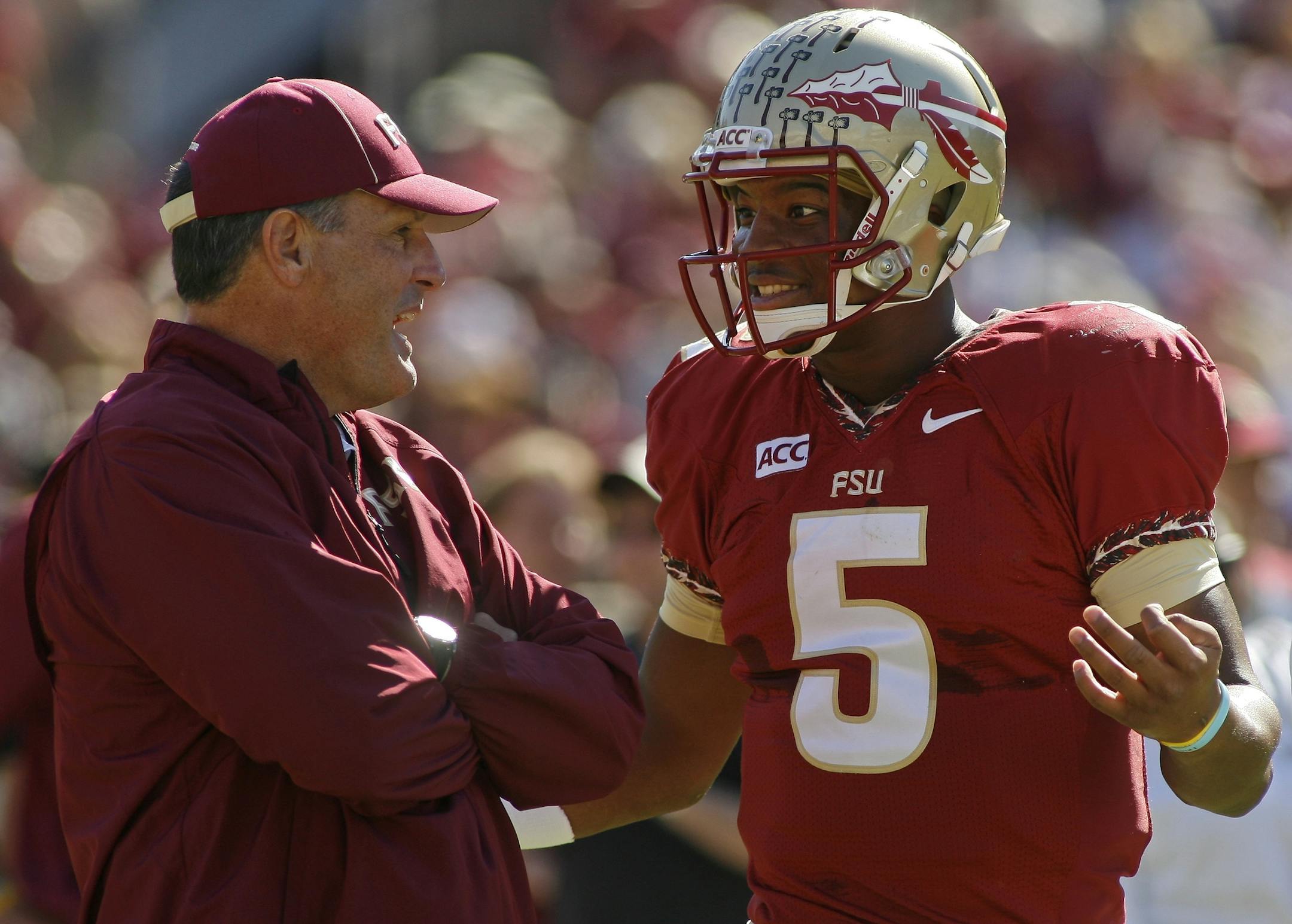 Florida State tight ends coach Tim Brewster chats with quarterback Jameis Winston (5) before the start of an NCAA college football game against North Carolina State on Saturday, Oct. 26, 2013, in Tallahassee, Fla. Florida State beat North Carolina State 49-17. (AP Photo/Phil Sears) ORG XMIT: FLPS130