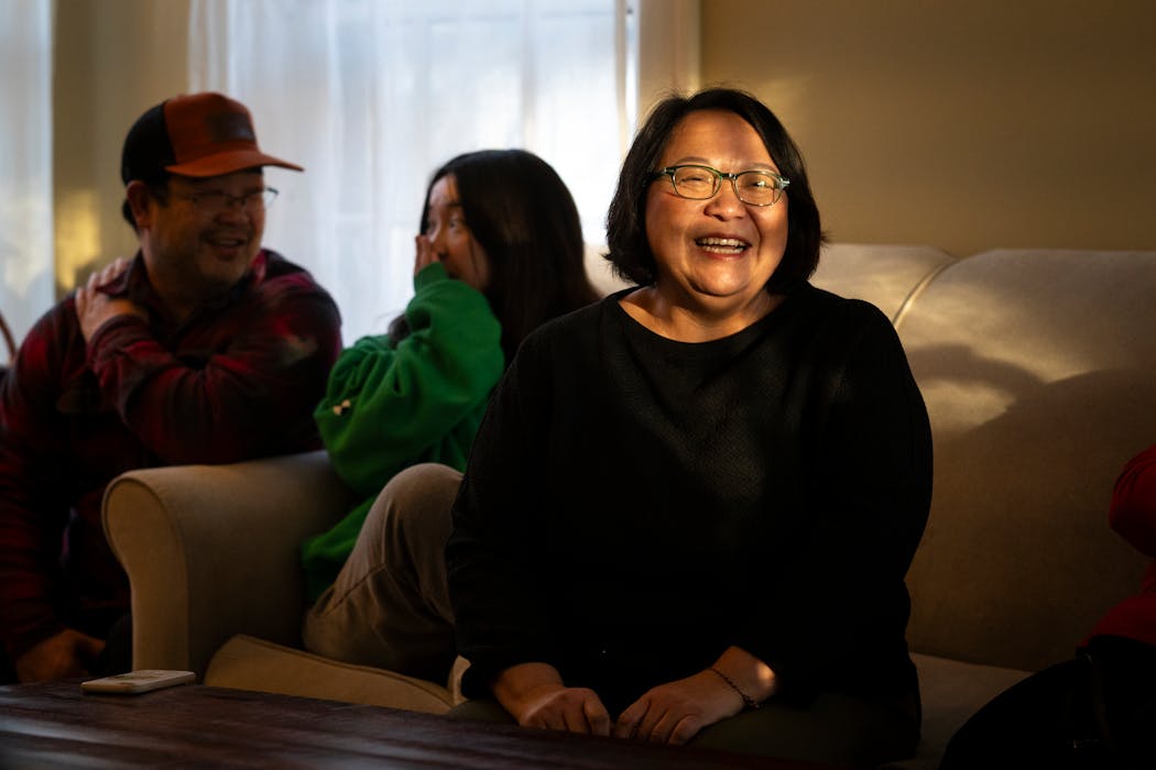 With her family beside her, Bo Thao-Urabe, a founding member of the Asian-American philanthropic family group “Bad Mo Pho Phamily” (BMPP), speaks at the group’s year-end gathering in St. Paul.