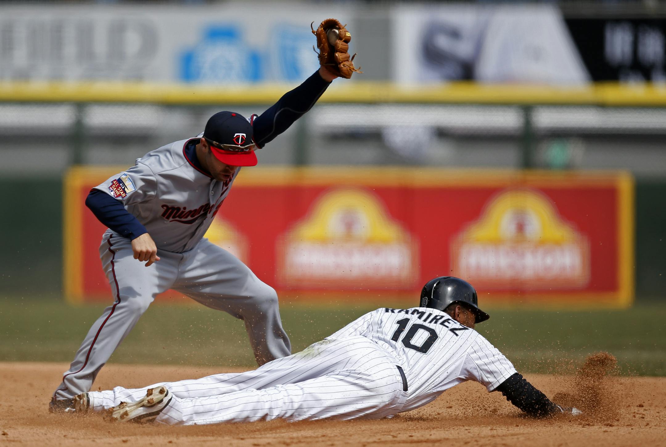 Chicago White Sox' Alexei Ramirez steals second under Minnesota Twins second baseman Brian Dozier during the fourth inning of a baseball game on Wednesday, April 2, 2014, in Chicago. (AP Photo/Andrew A. Nelles)