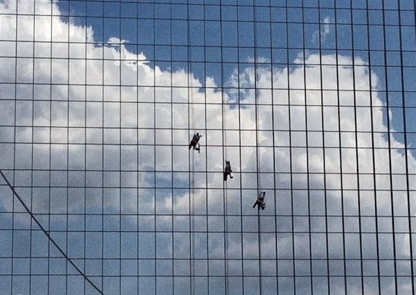 A trio of window washers scales the glass side of the former Federal Reserve Bldg ( Nicollet Mall and Washington Av.) in downtown Minneapolis.