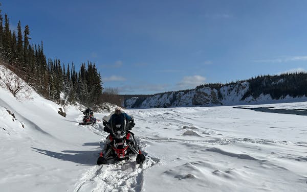 The "three old guys'' travel on the Porcupine River in Alaska, headed for Fort Yukon, a trip that was interrupted by a snowmobile fire.
