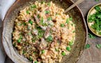 A bowl of creamy risotto with ham and peas.