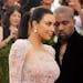 File-This May 4, 2015, file photo shows Kim Kardashian, left, and Kanye West arriving at The Metropolitan Museum of Art's Costume Institute benefit ga