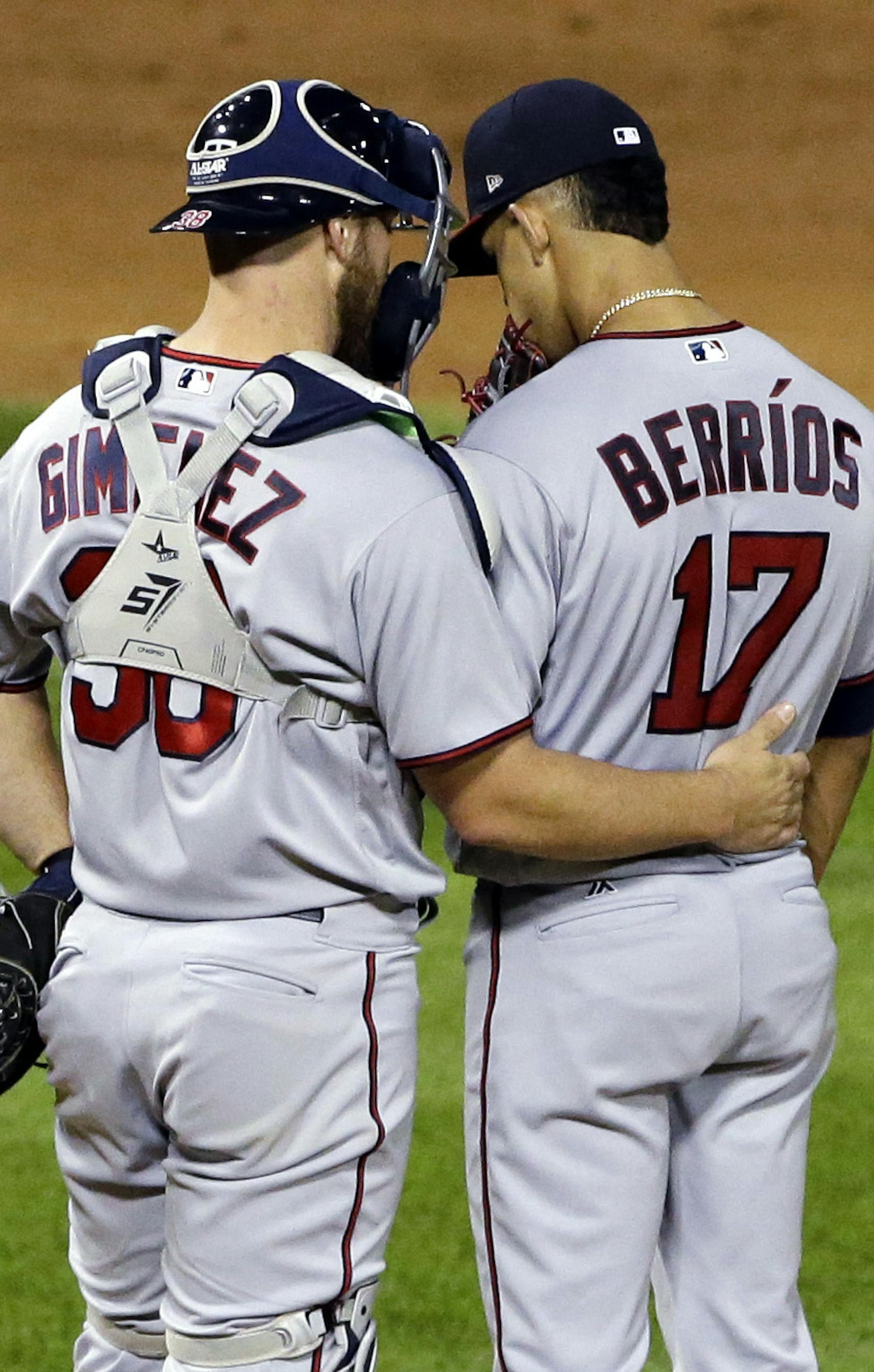 Minnesota Twins catcher Chris Gimenez, left, talks with starting pitcher Jose Berrios as third baseman Ehire Adrianza watches during the fourth inning of a baseball game against the Chicago White Sox, Thursday, Aug. 24, 2017, in Chicago. (AP Photo/Nam Y. Huh)