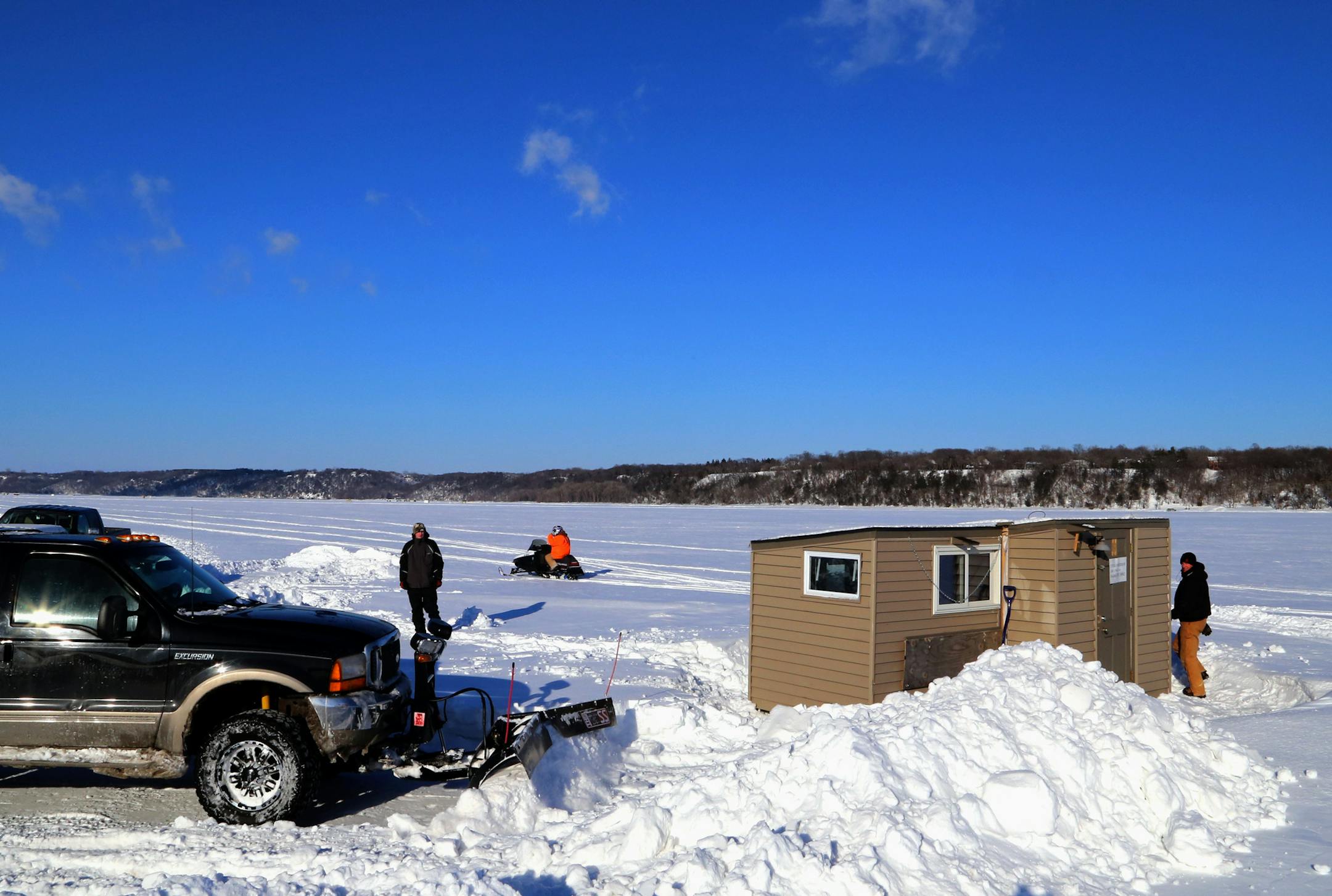 Saved by a big plow truck: The ice fishing house owned by Dennis Anderson and his son, Cole, was reached, finally, on the St. Croix River after Dean Welk of North St. Paul blasted through about a half-mile of drifted, hard-packed snow with a 1-ton Ford rigged with a V plow. Fish houses were due off the river at midnight Saturday. Doubtless, given snow conditions on the river, some are still there.