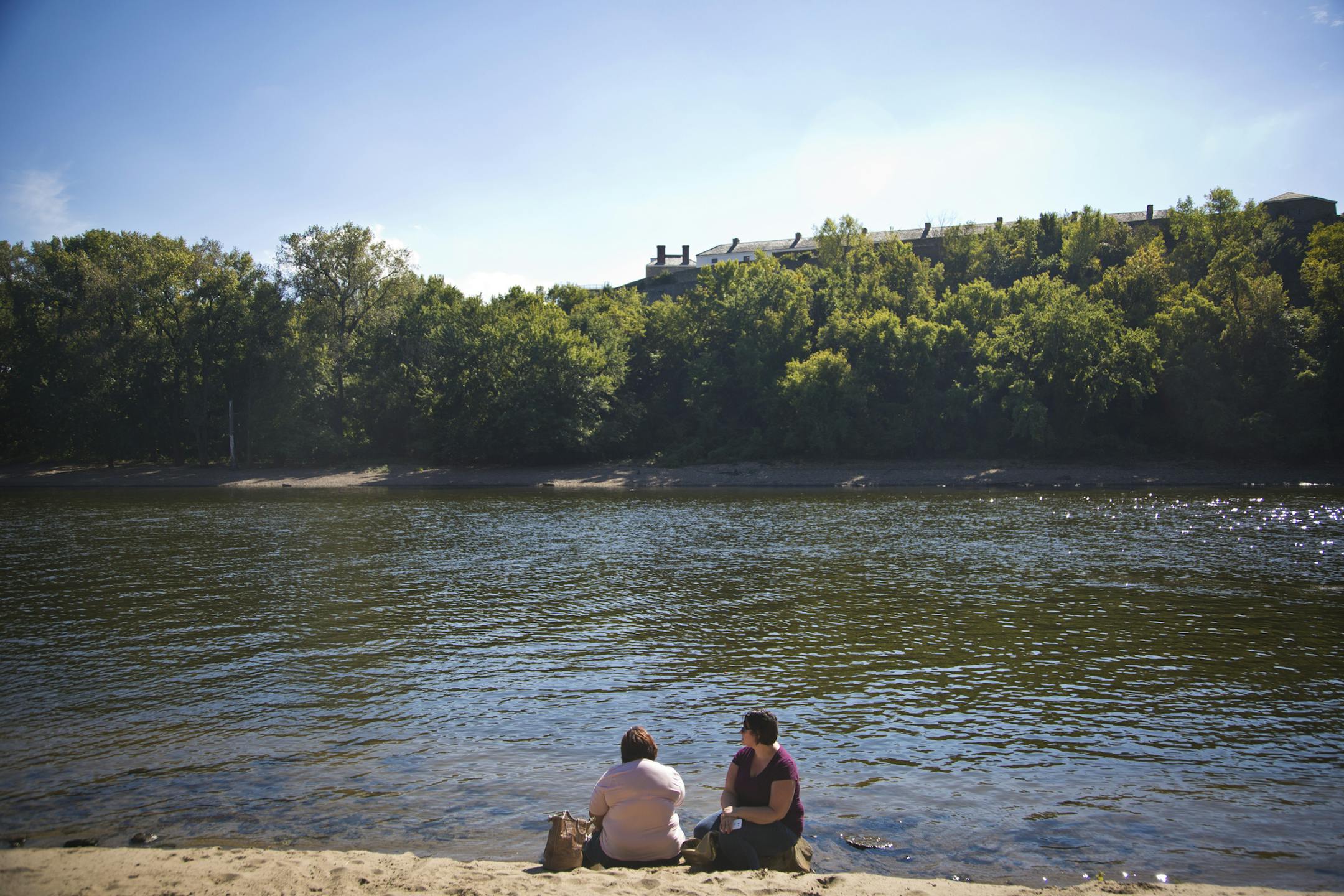 Angela Rubio and Leona Pliego sat along the shore of the Mississippi River on Tuesday, September 24, 2013, in St. Paul, Minn. ] (RENEE JONES SCHNEIDER • reneejones@startribune.com)