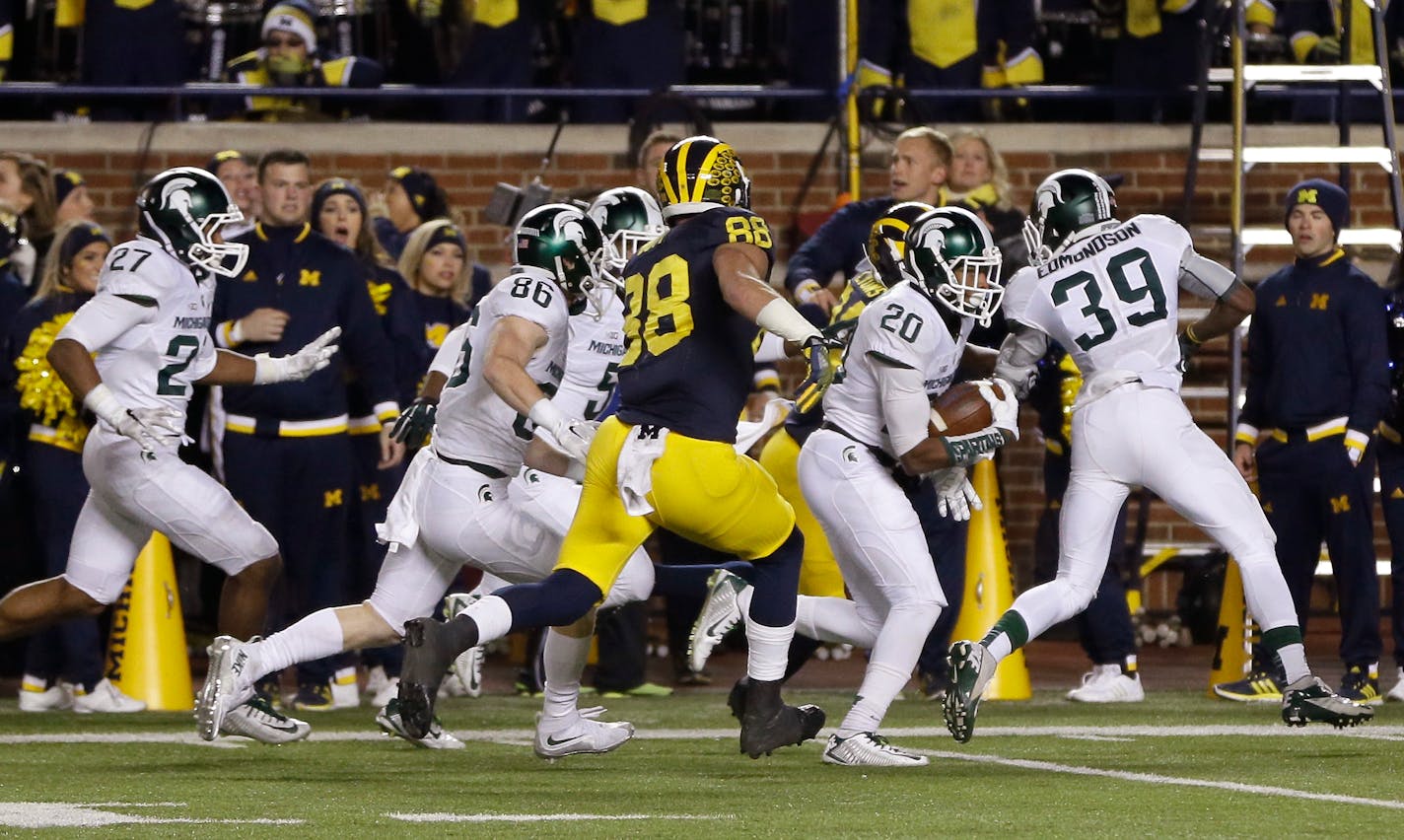 Michigan State defensive back Jalen Watts-Jackson (20) runs towards the end zone after recovering a fumbled snap on a punt in the closing seconds of the second half of an NCAA college football game, Saturday, Oct. 17, 2015, in Ann Arbor, Mich.