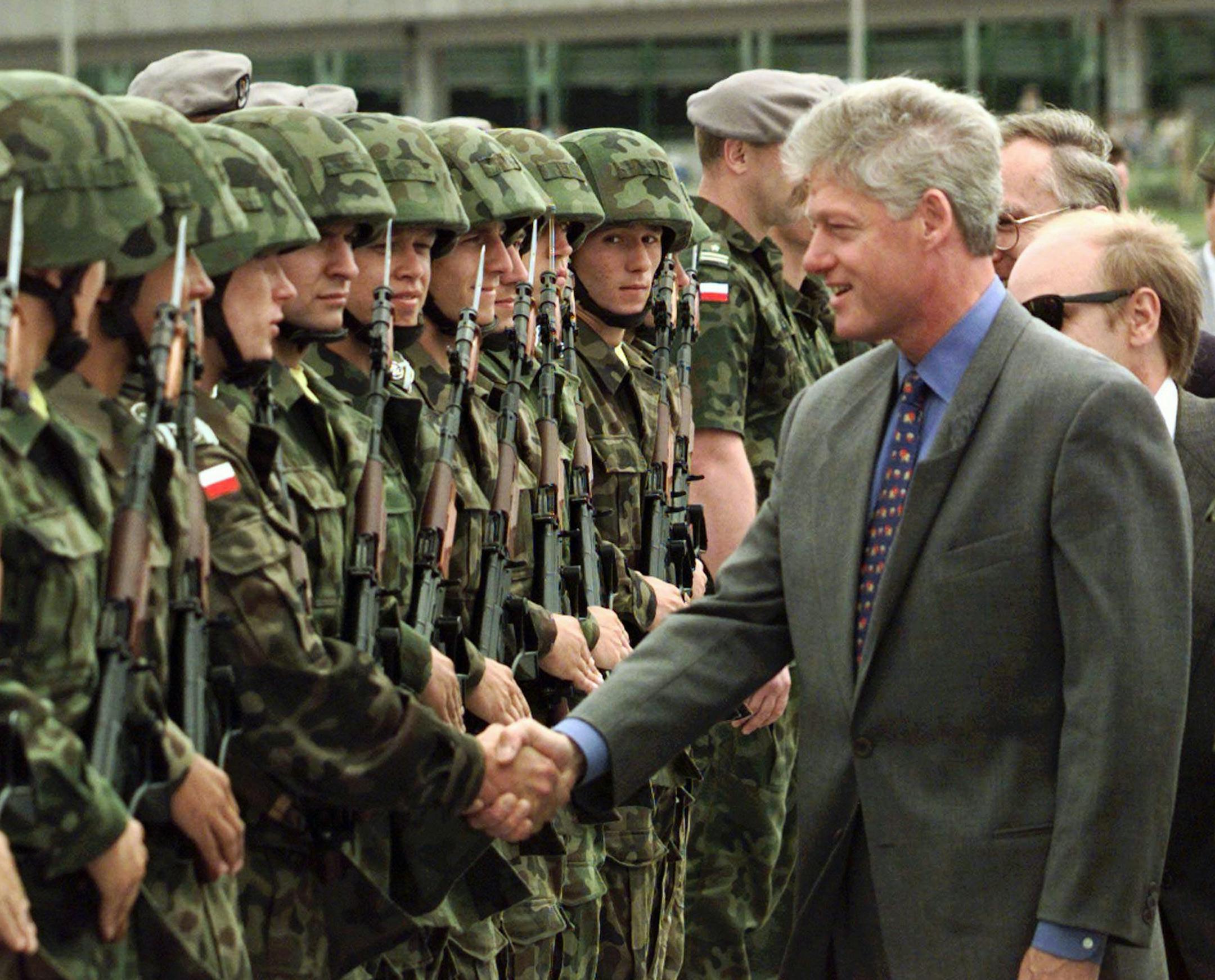 President Clinton greets Polish troops upon arriving at Warsaw Airport Thursday July 10 1997. Poland, the next in line to join NATO, embraced President Clinton today with a red-carpet celebration of his work championing their closer military and economic ties with the West. (AP PHOTO/J.Scott Applewhite) ORG XMIT: WAR150