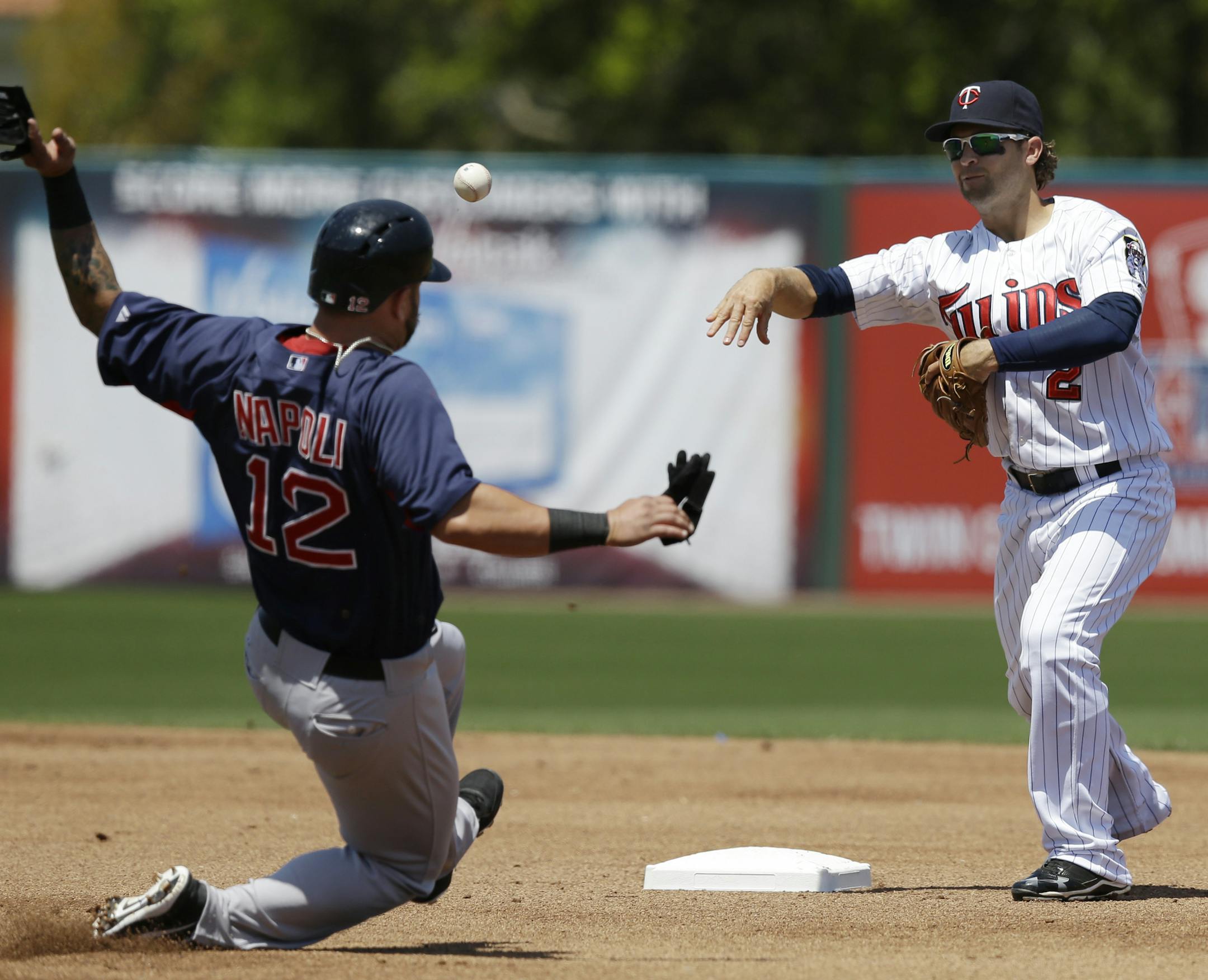 Boston Red Sox's Mike Napoli is forced out at second as Minnesota Twins shortstop Brian Dozier (2) turns a double play on Red Sox's Will Middlebrooks grounder in the second inning of an exhibition spring training baseball game in Fort Myers, Fla., Friday, March 29, 2013. (AP Photo/Elise Amendola)