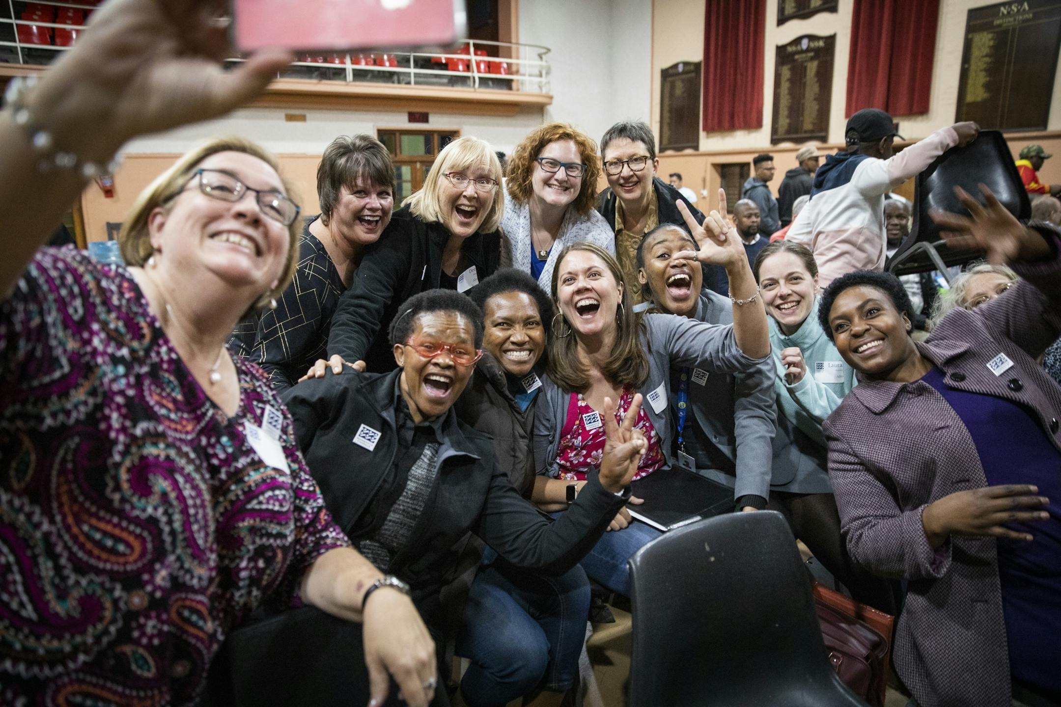 Singers in the tenor section take a group selfie just after meeting before rehearsal begins.