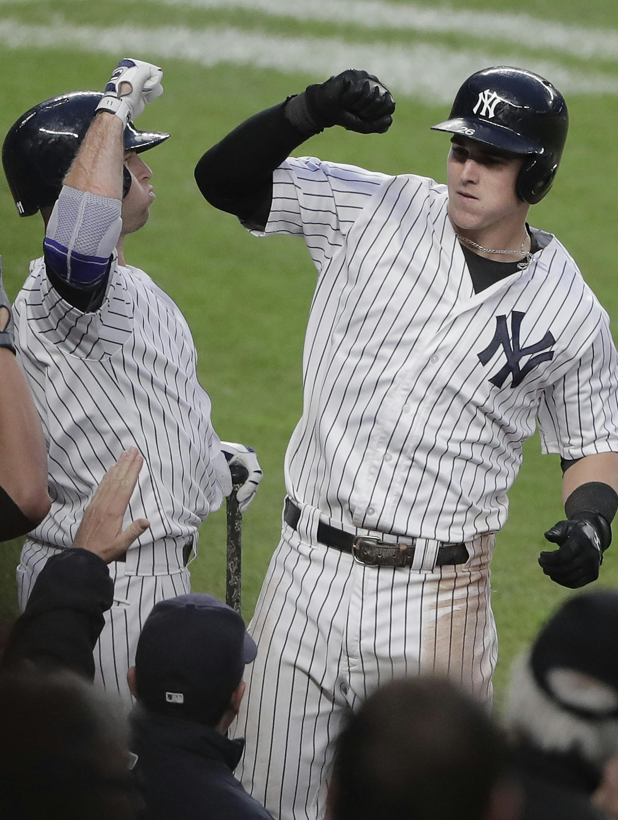 New York Yankees' Tyler Austin, right, celebrates with Mark Teixeira after hitting a solo home run against the Baltimore Orioles during the seventh inning of a baseball game, Saturday, Oct. 1, 2016, in New York. The Yankees won 7-3. (AP Photo/Julie Jacobson)