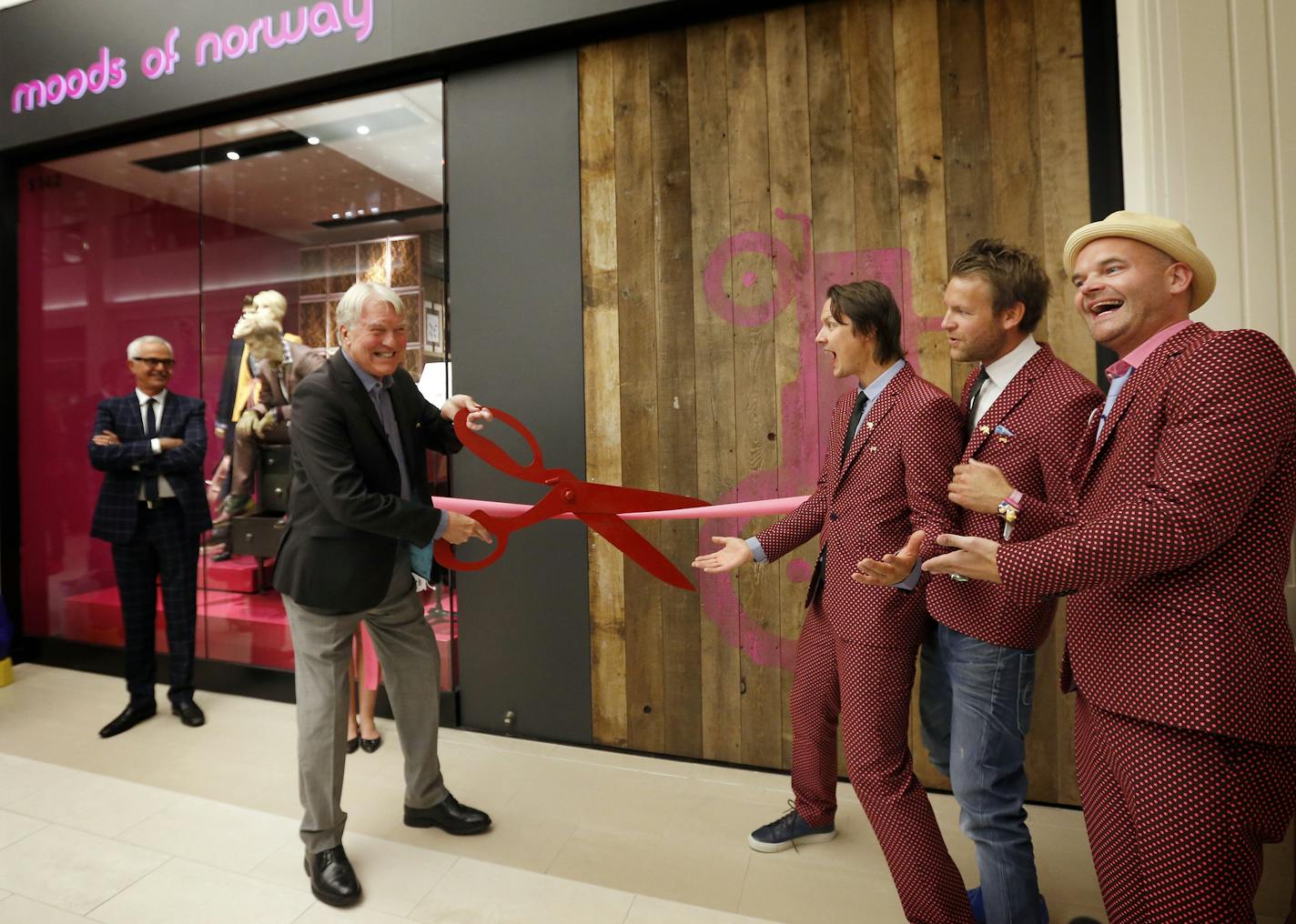 Gary Gandrud, Norway's honorary Consul General posed for photos at the ribbon cutting at the grand opening of the new Moods of Norway store at the Mall of America as the company's founders Peder Borresen, Simen Staalnacke, and Stefan Dahlkvist cheered. ] CARLOS GONZALEZ cgonzalez@startribune.com September 5, 2013, Bloomington, Minn., Mall of America store opening - Moods of Norway , MOA, ribbon cutting of the new store at 6:30 p.m. and the party at Radisson Blu