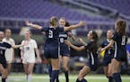 Lauren Heinsch celebrates with teammates after scoring the winning goal on a penalty kick, Mahtomedi beat Orono 3-2.