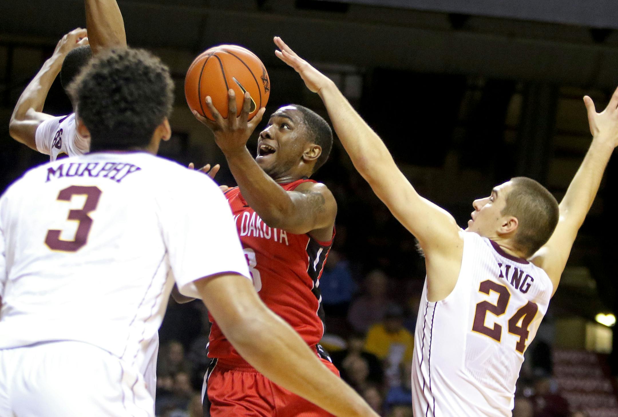 The University of Minnesota's Joey King (24) can't stop South Dakota's Shy McClelland (3) as he drives to the basket during the first half of the U of M's 85-81 double overtime loss to the University of South Dakota at Williams Arena Saturday, Dec. 5, 2015, in Minneapolis, MN. ](DAVID JOLES/STARTRIBUNE)djoles@startribune.comUniversity of Minnesota men&#xed;s basketball versus South Dakota at Williams Arena Saturday, Dec. 5, 2015, in Minneapolis, MN.