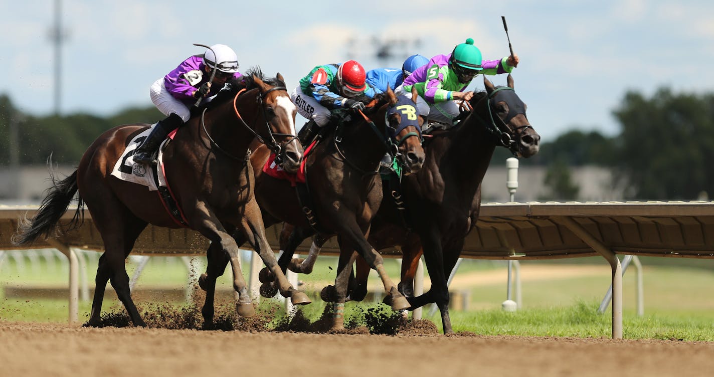 FILE: Hold for More, ridden by jockey Dean Butler (center) pulls ahead of Bourbon County (left) and Smooth Chiraz (right) in the home stretch of the Crocrock Minnesota Sprint Championship last summer.