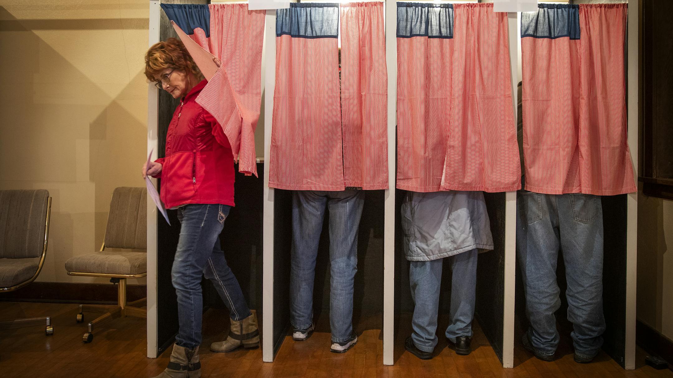 Christine Giroux exits the voting booth at Transit Town Hall, Tuesday, Nov. 6, 2018. At 91.4 percent, in 2016, Sibley County had one of the highest percentage of votes cast at a polling place of any county in the state. (Leila Navidi/Star Tribune via AP)