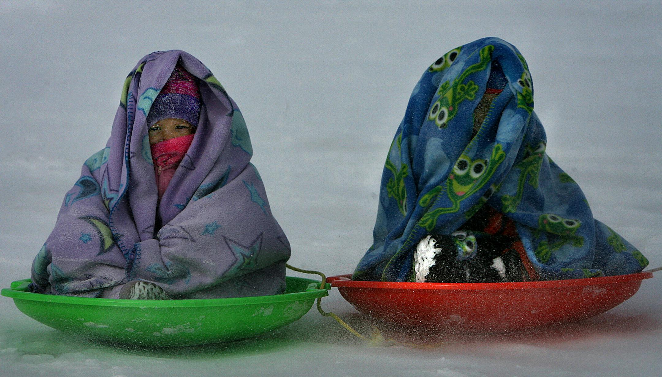 JIM GEHRZ Ô jgehrz@startribune.com Medicine Lake/February 9, 2007/12:30PM] Two-and-a-half year old Kahlia Miller (left) and her brother, Isaiah, 5, were bundled up to protect themselves from the bitter cold wind on Medicine Lake, where organizers hoped to set a world record for the longest bunny hop and largest social dance on a frozen lake. The children's mother, Natasha Miller, and grandmother, Roberta Miller, all from Plymouth, participated in the attempt. According to organizer Robert M