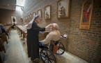 Sister Mary Alphonsus marked an ashen cross on the forehead of a resident and others in the chapel during the Ash Wednesday Mass at Little Sisters of 