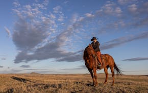 Liz Barbour, manager of the Cinch Buckle Ranch in Broadus, Mont., rides out to check cattle on the morning of April 22, 2024. The Cinch Buckle borders
