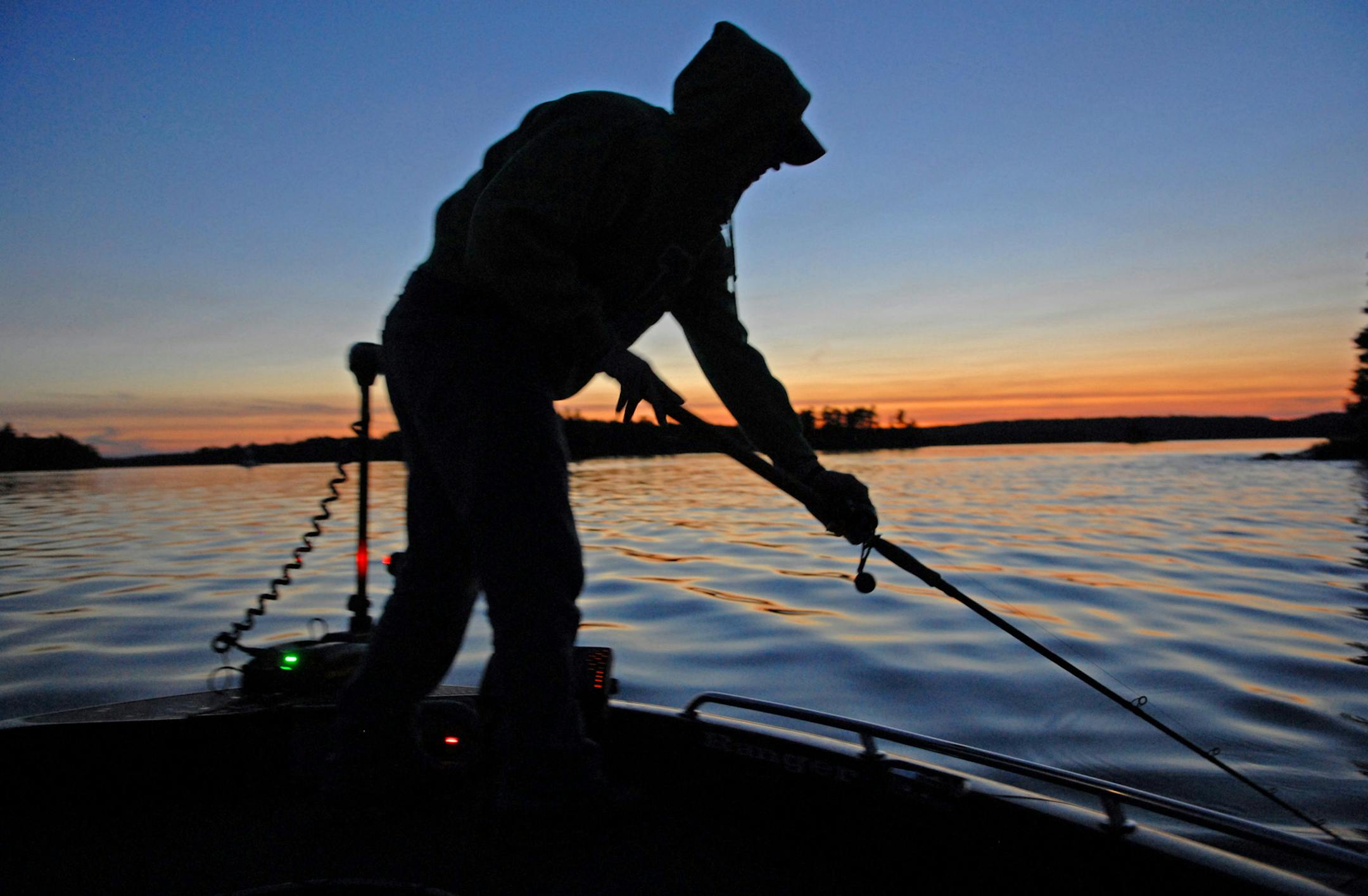 Dominic Schneider, 20, of Maplewood, a student at the University of North Dakota, conducted a cast-ending figure 8 with his muskie bait Wednesday at sunset on Lake of the Woods, trying to entice a muskie to bite.