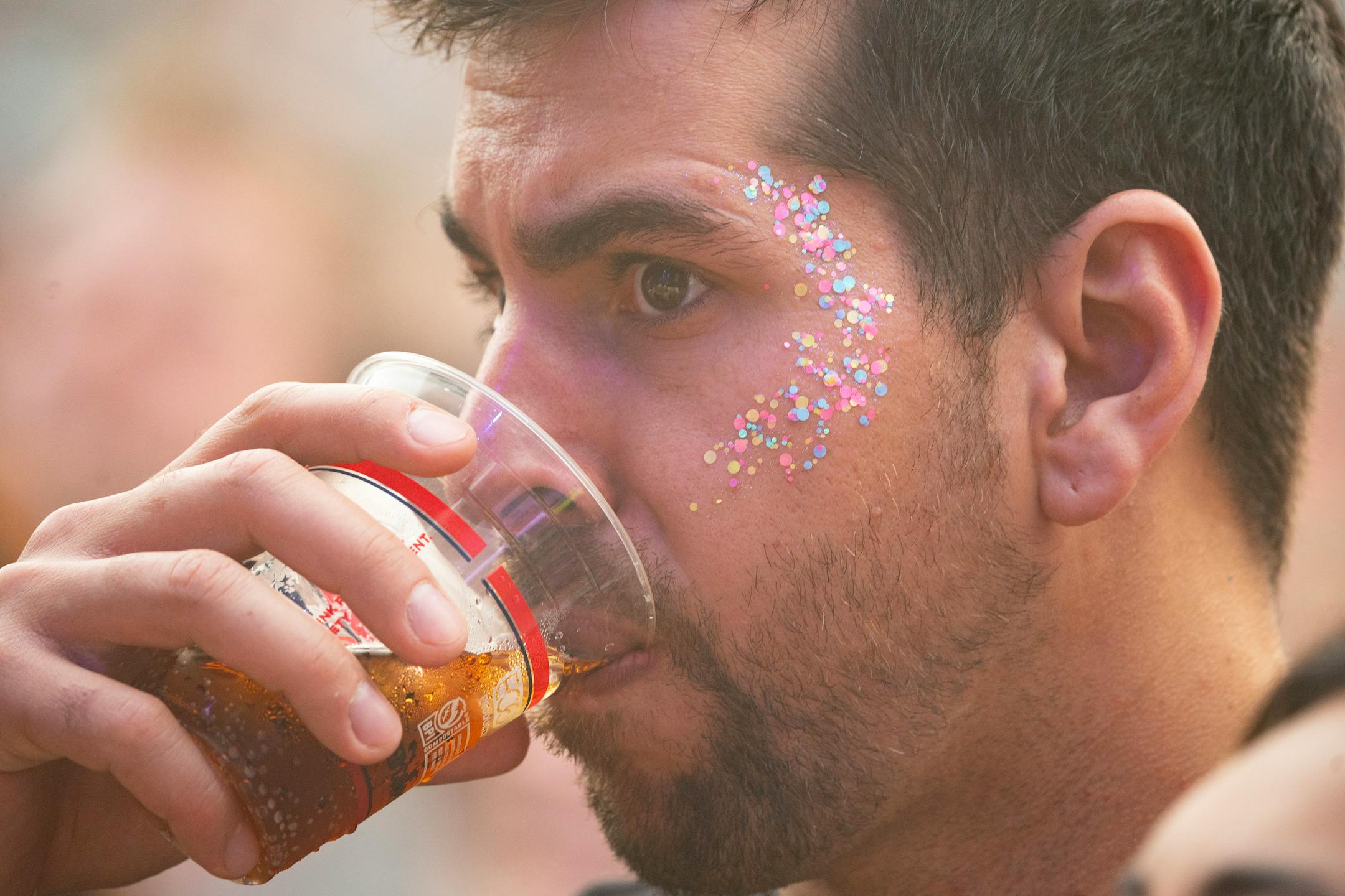 A fan sips a beer while Death Cab for Cutie performs at TC Summer Fest Friday, July 14, 2023, at Target Field in Minneapolis.
