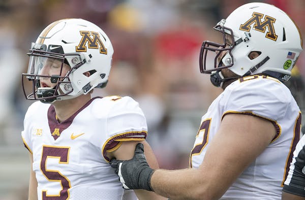 Minnesota's quarterback Zack Annexstad was helped up after he was sacked by Maryland's linebacker Tre Watson during the third quarter as Minnesota too