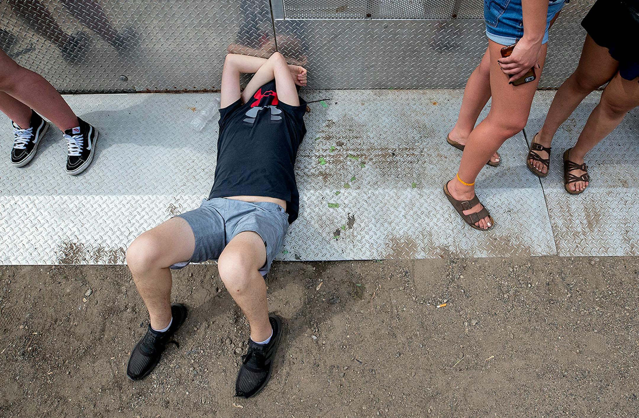A fan shielded his face from the sun.