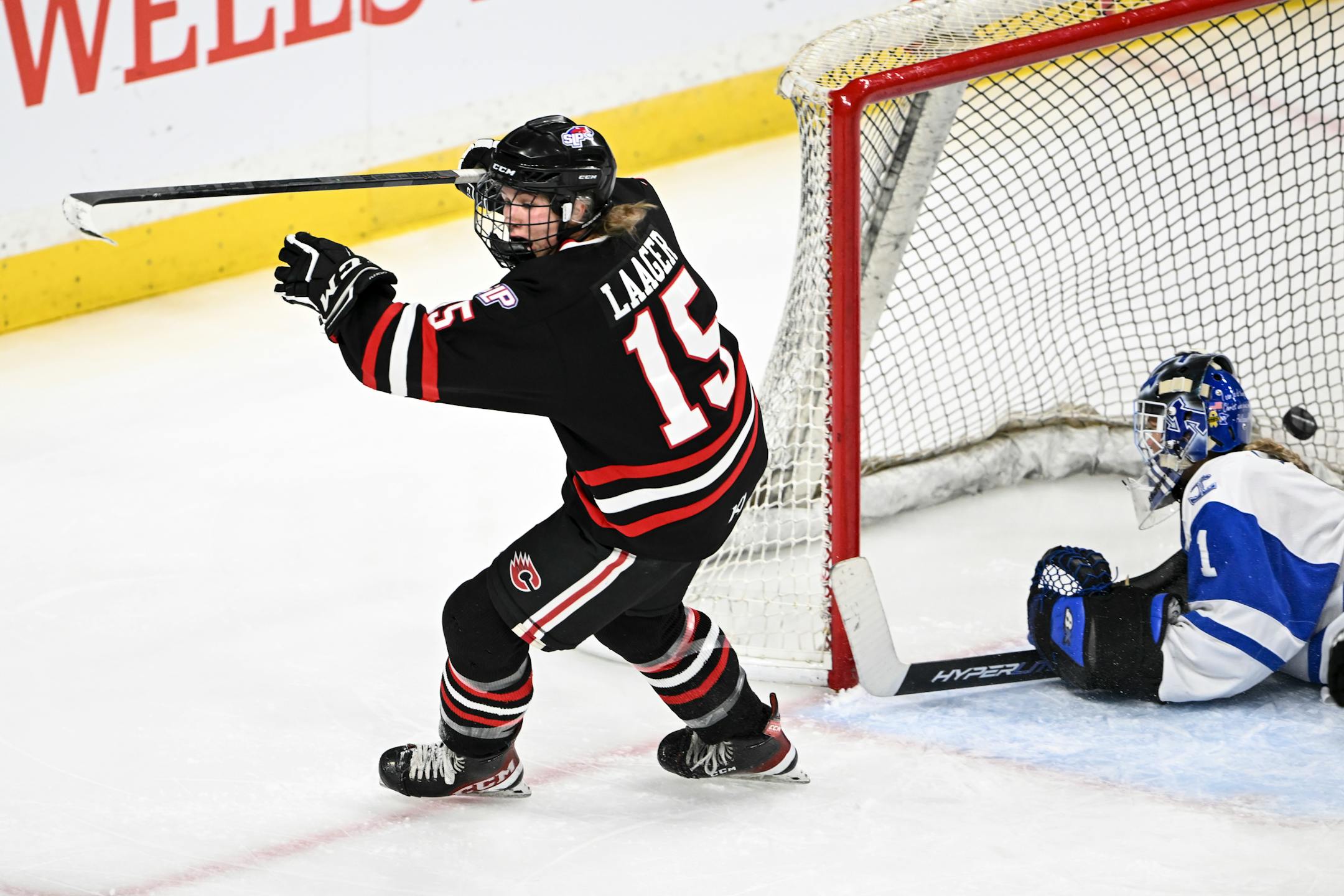 Centennial/Spring Lake Park forward Grace Laager (15) scores a goal against Minnetonka goaltender Layla Hemp (1) to tie the game late in the third period.