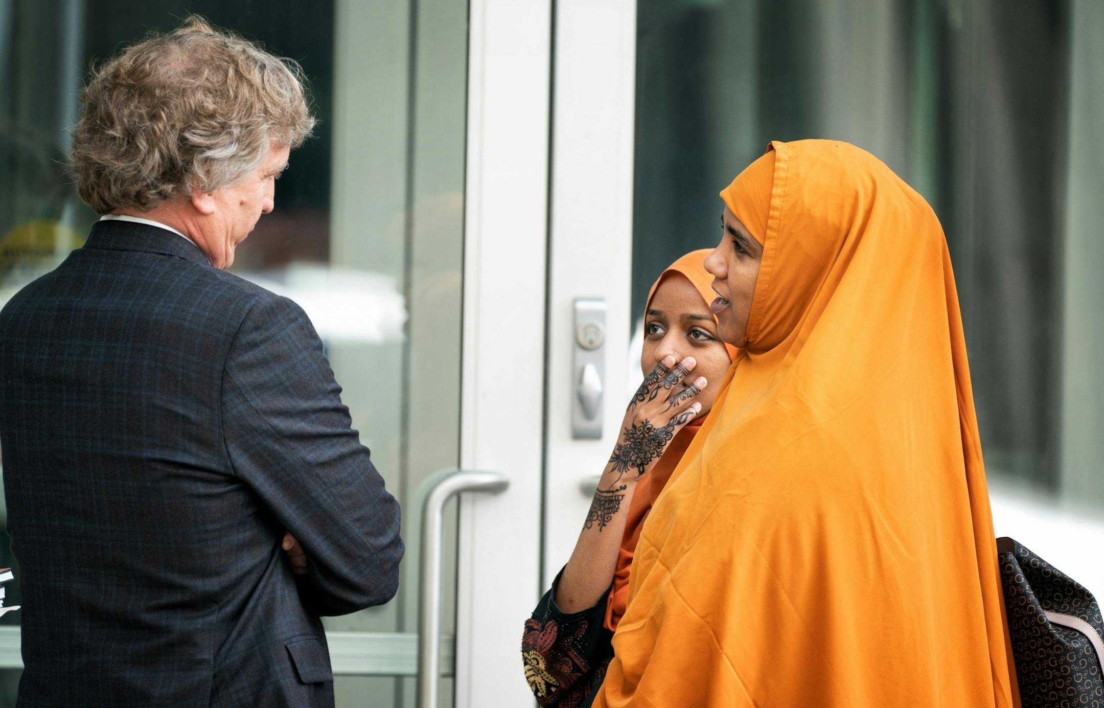 Attorney Bruce Nestor talked with relatives of his client Abdirahman Daud right, and Naema Ahmed, center.