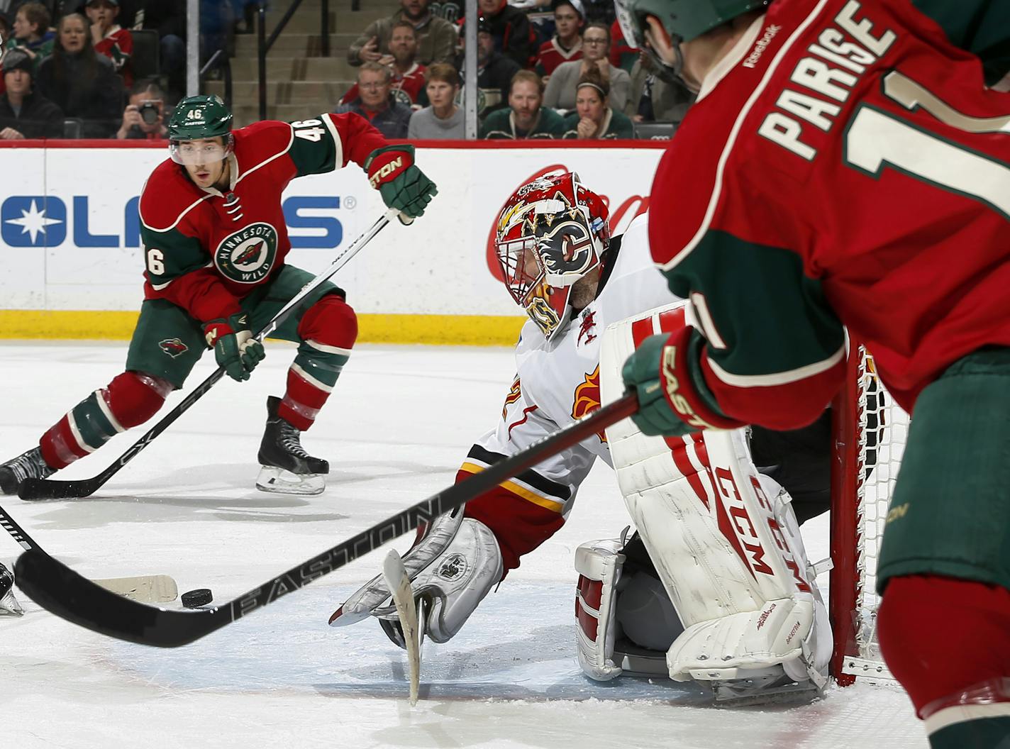 Zach Parise (11) passed the puck by Calgary Flames goalie Niklas Backstrom to set up a goal by Jared Spurgeon (46) in the third period. ] CARLOS GONZALEZ cgonzalez@startribune.com - March 24, 2016, St. Paul, MN, Xcel Energy Center, NHL, Hockey, Minnesota Wild vs. Calgary Flames