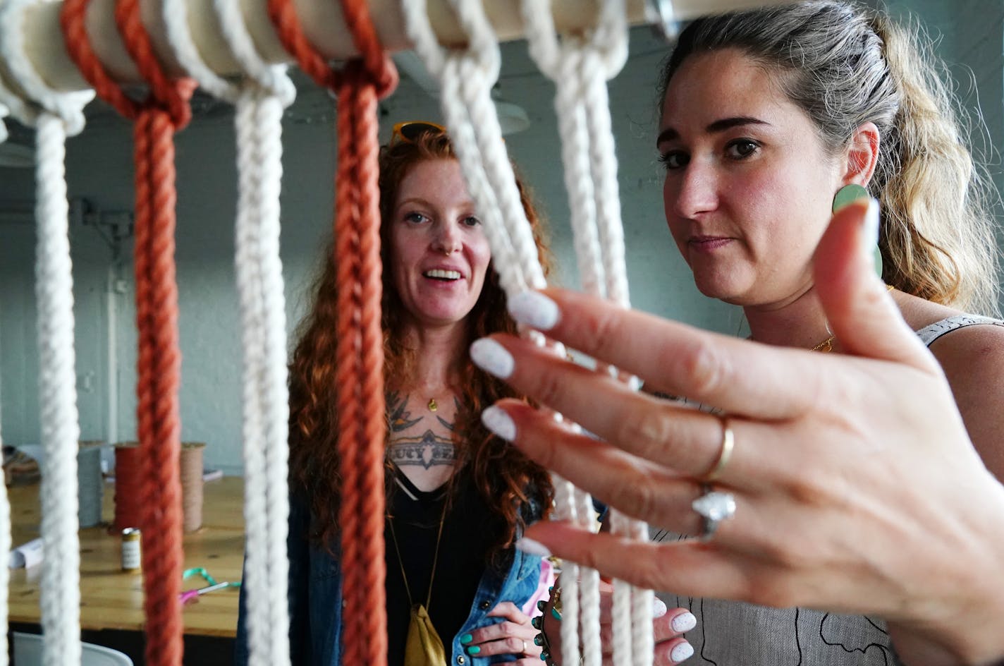 Emily Katz helped Josie Jennings with her macrame project during the class. ] ANTHONY SOUFFLE &#xef; anthony.souffle@startribune.com Emily Katz, author of Modern Macrame and known by her Instagram followers as the "Queen of macrame," taught a workshop on the craft to locals as part of a traveling program Wednesday, July 25, 2018 at LAB MPLS in Minneapolis.