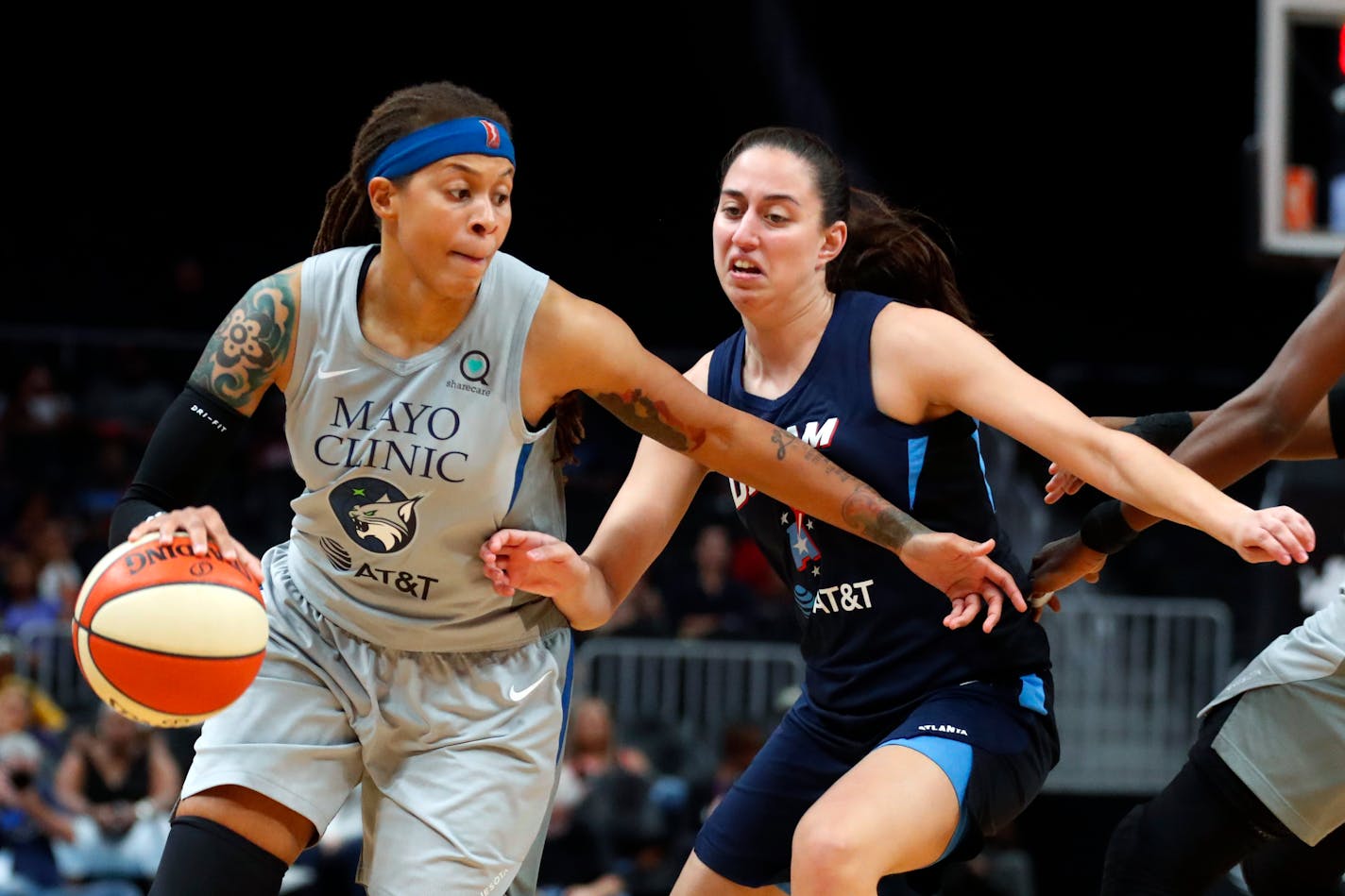 Seimone Augustus drives against Atlanta guard Maite Cazorla