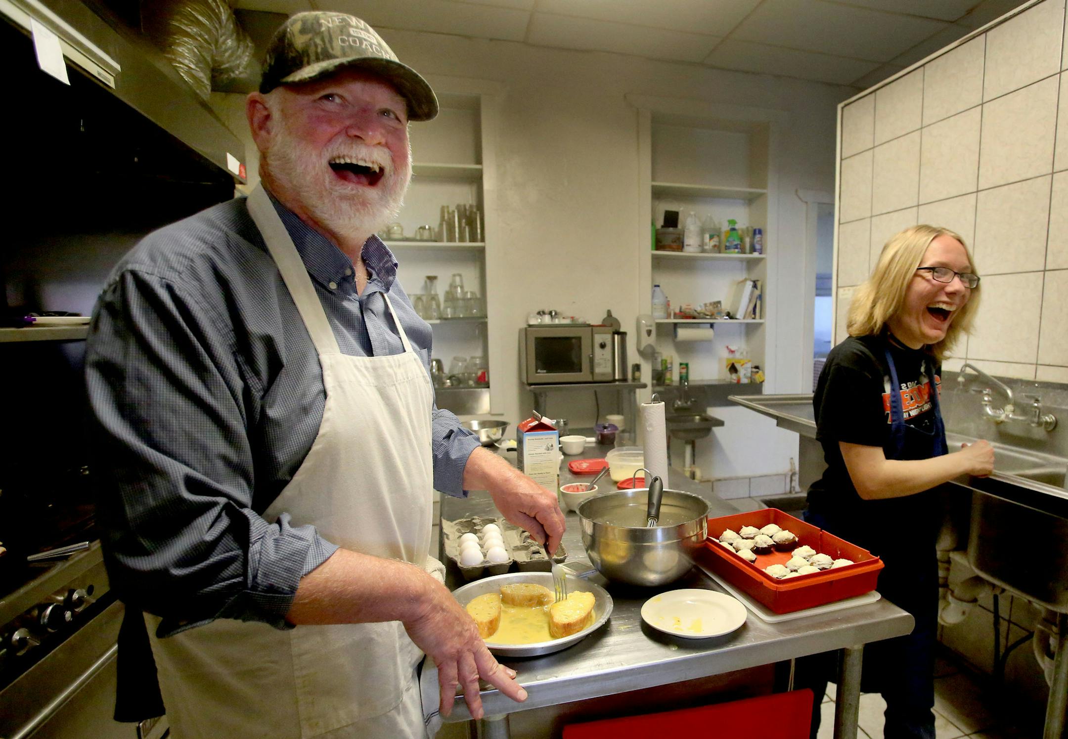 Laughter erupts as Olson prepares french toast for a customer and Amber Karges, who serves at the Inadvertent Cafe and also works at Main Street Industries which is a DT and H facility, pauses briefly from washing dishes as they chat with customers through an opening between the kitchen and dining room Wednesday, June 8, 2016, in Clinton, MN.](DAVID JOLES/STARTRIBUNE)djoles@startribune Brent Olson never had any aspirations to run a small-town cafe. He's a writer. A county commissioner. But for m