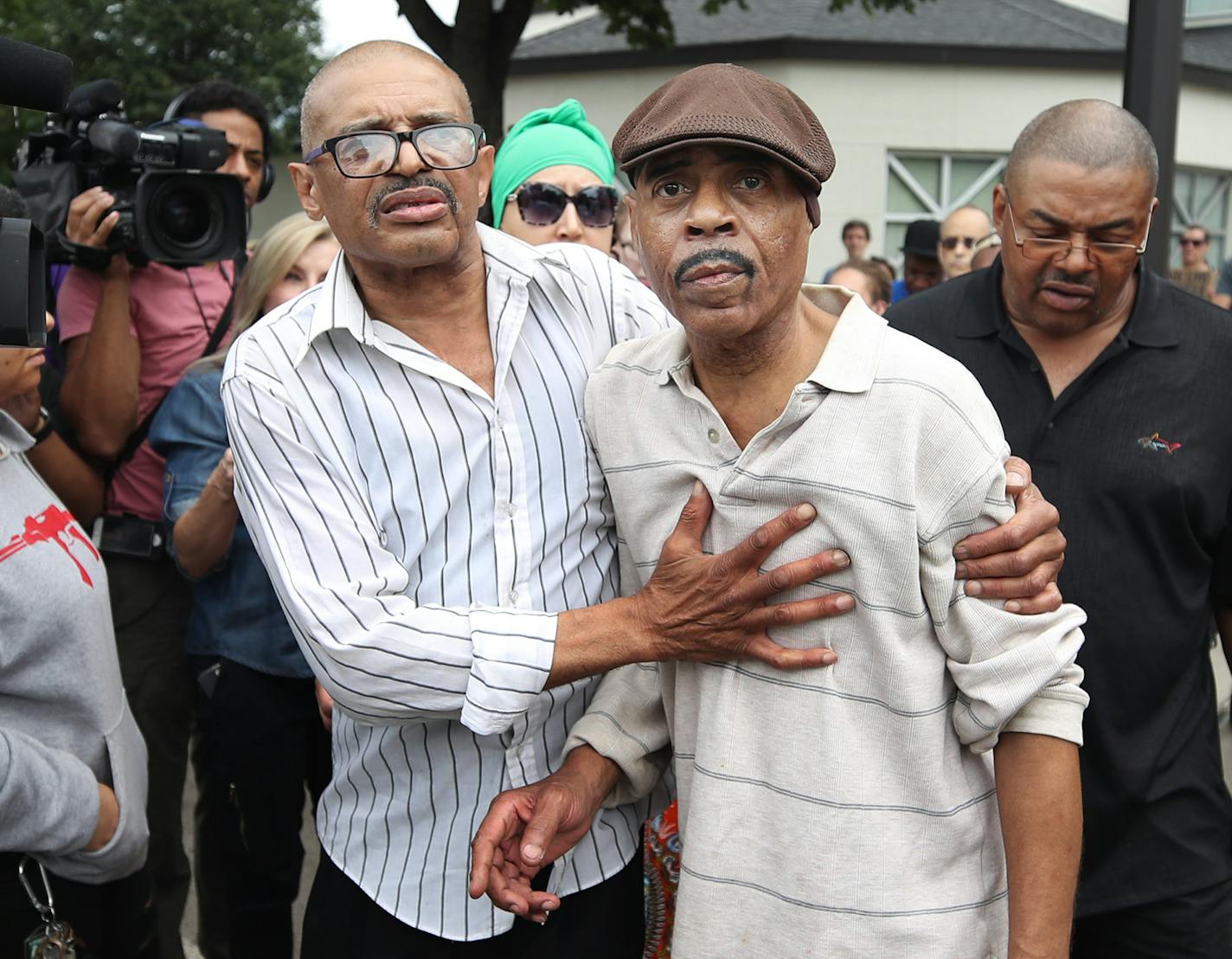 Manuel Moore brother of (Thurman Blevins) left escorted his father Thurman Moore to there car after speaking to members of the north side community during a protest and rally at the 4th precinct. Manuel spoke about his brother and asked for a peaceful protest in front of the police station on Plymouth Avenue in response to the shooting death of Thurman Blevins by Minneapolis Police Sunday June 24, 2018 in Minneapolis, MN. ] JERRY HOLT &#xef; jerry.holt@startribune.com