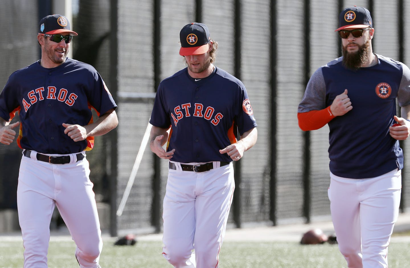 Houston Astros pitchers Justin Verlander, left, Gerrit Cole, center, and Dallas Keuchel jog as they warm up during spring training baseball practice Thursday, Feb. 15, 2018, in West Palm Beach, Fla. (AP Photo/Jeff Roberson)