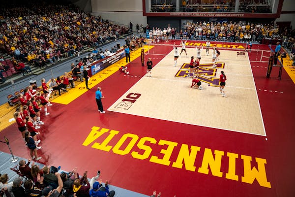 The University of Minnesota volleyball team celebrates after winning a point in the first second against the University of South Dakota in the first r
