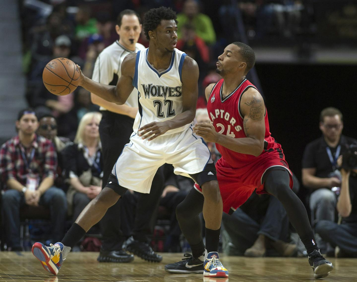 Minnesota Timberwolves forward Andrew Wiggins drives to the net past Toronto Raptors guard Norman Powell during the second half of an NBA preseason basketball game, Wednesday, Oct. 14, 2015 in Ottawa, Ontario. The Timberwolves defeated the Raptors 89-87. (Adrian Wyld/The Canadian Press via AP) MANDATORY CREDIT ORG XMIT: MIN2015102113595027