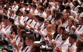 Medical students applaud during the University of Minnesota Medical School's annual White Coat Ceremony for the class of 2026 Friday, Aug. 19, 2022 at
